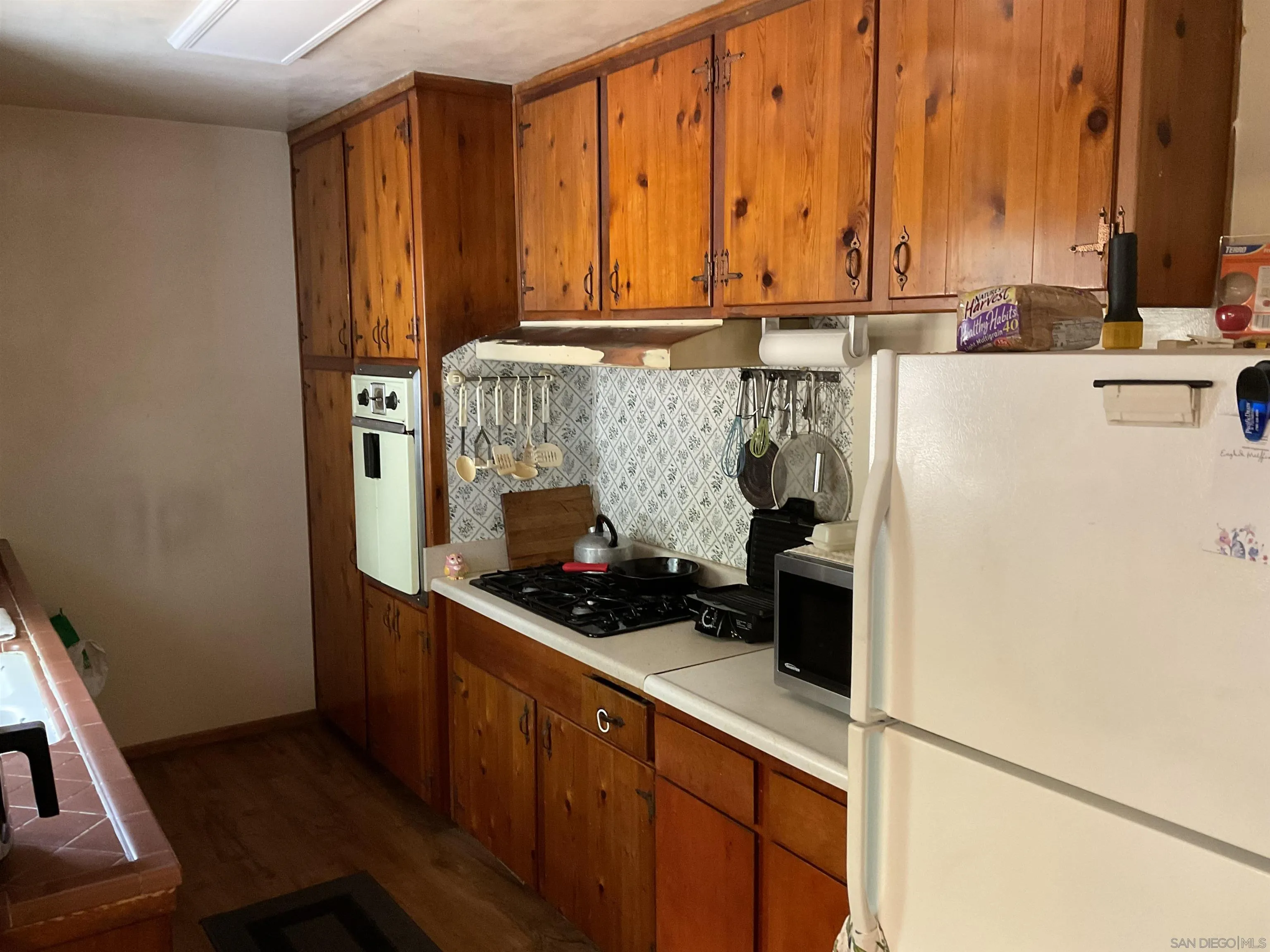 1221 Rees Road Escondido, CA 92026 - Photo 5 of 20 a kitchen with a sink and cabinets