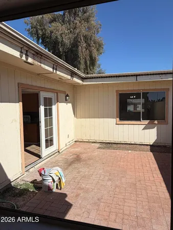 a view of a porch with a table and chairs and potted plants