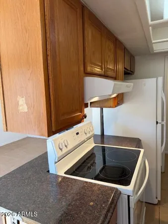 a kitchen with a refrigerator sink and cabinets