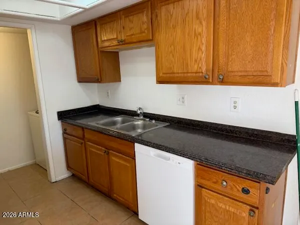 a kitchen with granite countertop cabinets and black appliances