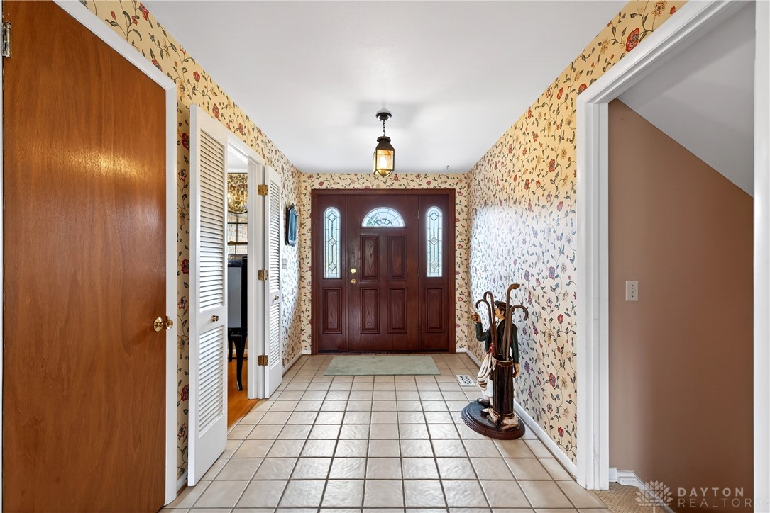 1547 Ambridge Road Centerville, OH 45459 - Photo 4 of 79 Step inside this inviting entry with classic tile flooring and a grand wooden door.