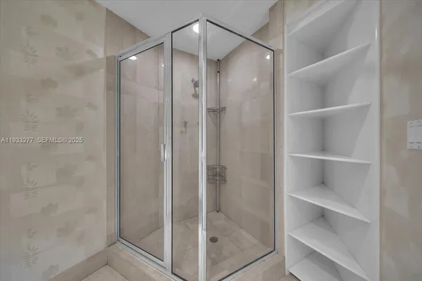 a bathroom with a sink a mirror and a shower