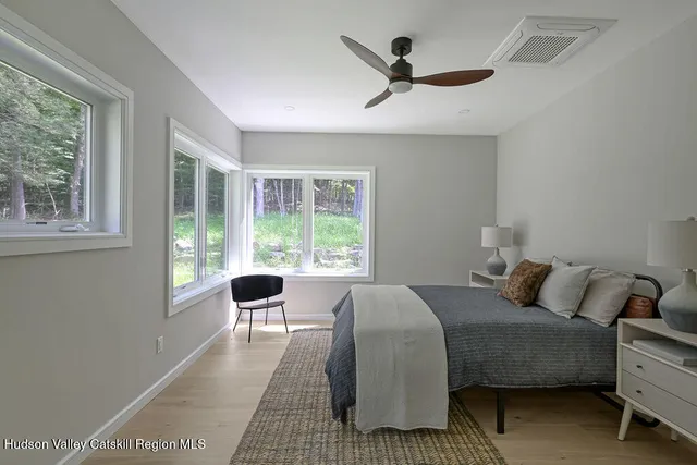 a bedroom with a bed windows and a window