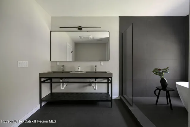 a view of bathroom with a sink and mirror