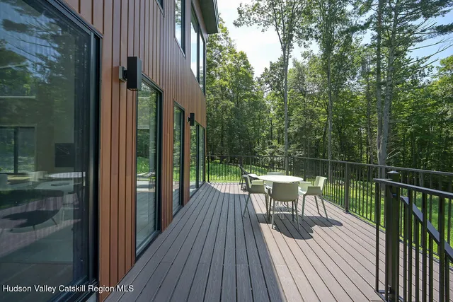 a view of a balcony with two chairs and wooden floor