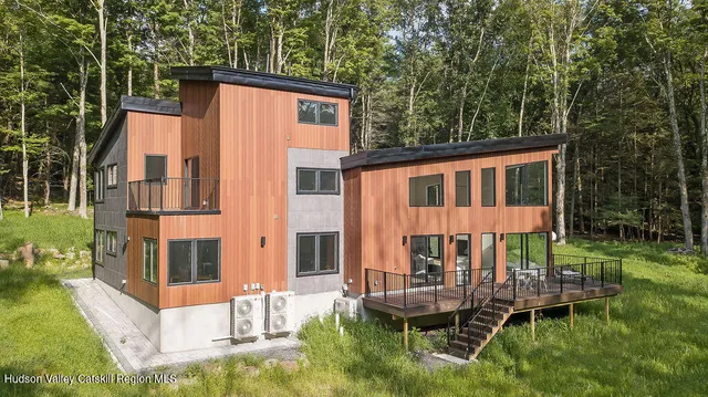aerial view of a house with a yard and sitting area