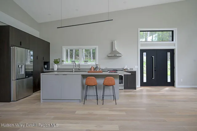 a kitchen with stainless steel appliances granite countertop a stove a sink and a refrigerator