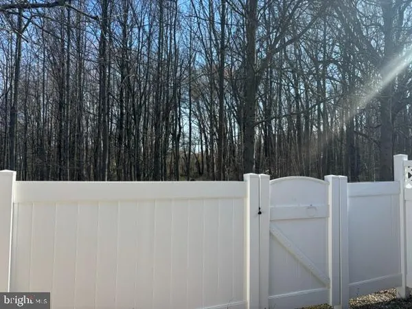 a white house with a trees in front of it