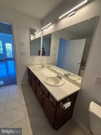 a bathroom with a sink a toilet and mirror