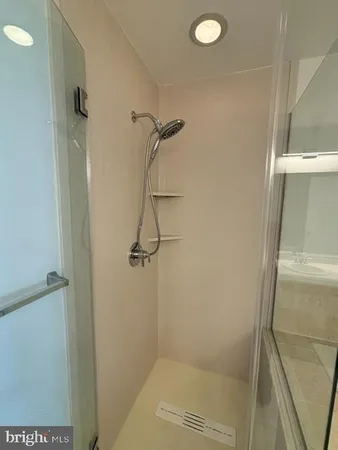 a bathroom with a glass shower door