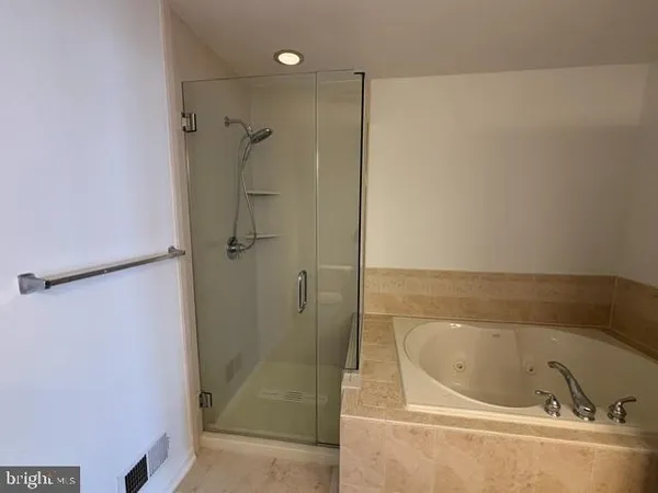 a bathroom with a bathtub and shower