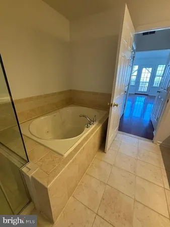 a bathroom with a tub and shower