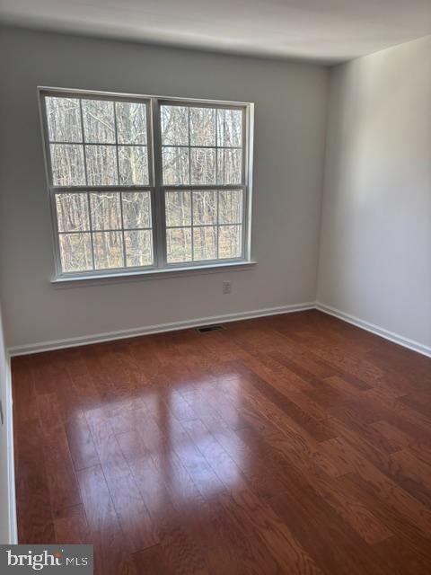 57 Windsor Pond Road Princeton Junction, NJ 08550 - Photo 28 of 37 an empty room with wooden floor and windows