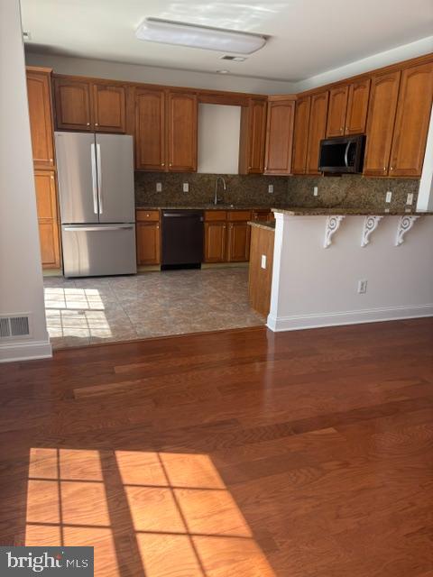 57 Windsor Pond Road Princeton Junction, NJ 08550 - Photo 30 of 37 a kitchen with kitchen island granite countertop a sink cabinets and stainless steel appliances