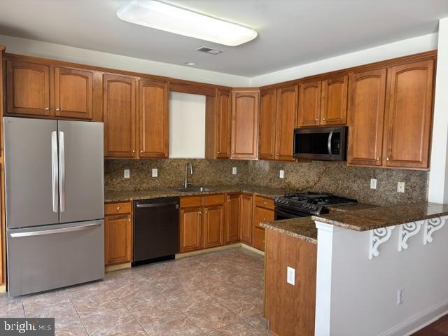 57 Windsor Pond Road Princeton Junction, NJ 08550 - Photo 6 of 37 a kitchen with granite countertop wooden cabinets a refrigerator and a sink