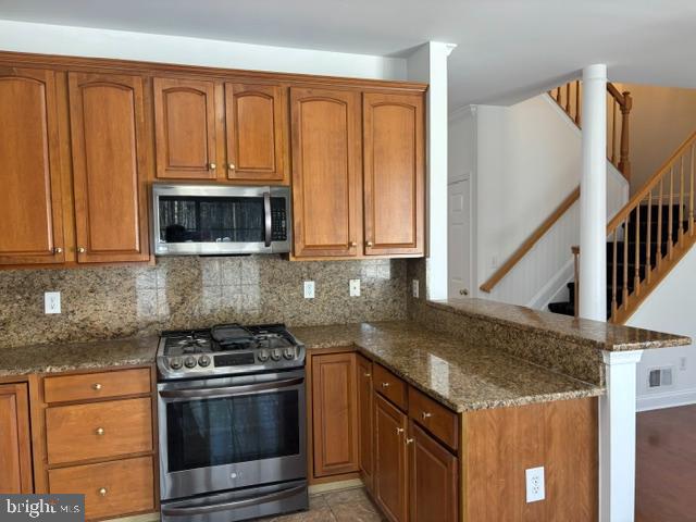 57 Windsor Pond Road Princeton Junction, NJ 08550 - Photo 7 of 37 a kitchen with stainless steel appliances granite countertop a stove a sink and a microwave