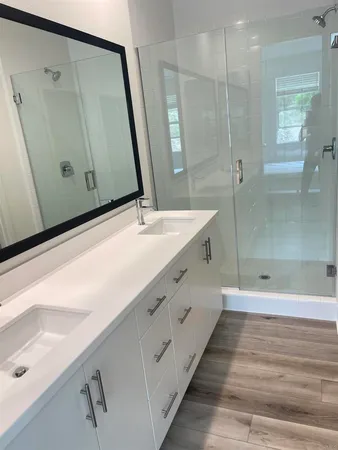 a bathroom with a double vanity sink and mirror