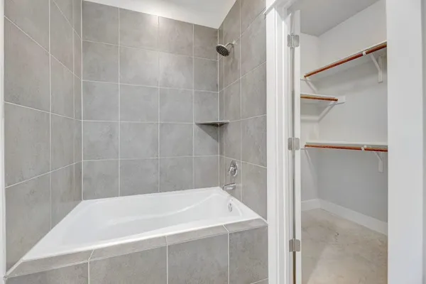 a bath tub sitting next to a shower