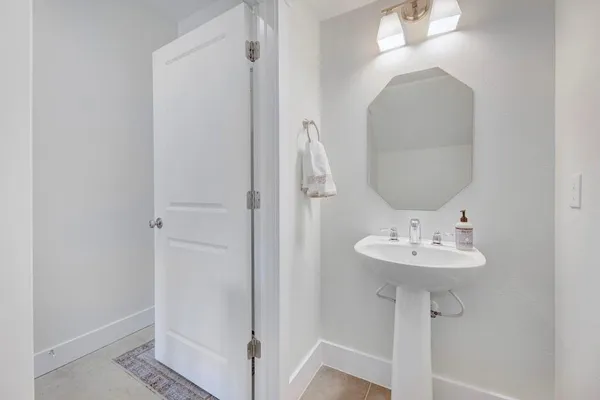a bathroom with a sink a mirror and shower