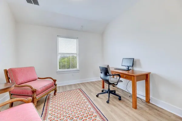 a work room with furniture and wooden floor