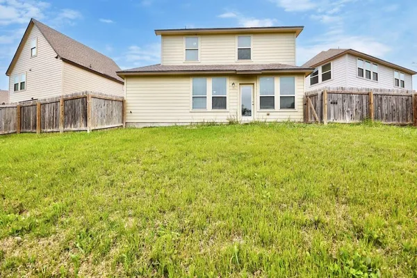 a view of a house with a backyard