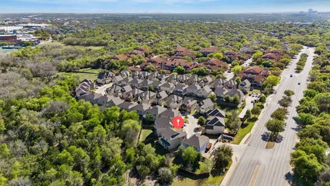an aerial view of a houses with a yard