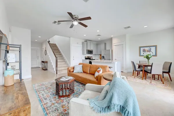 a living room with furniture and kitchen view