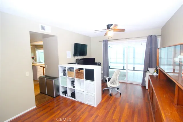 a living room with couches and a flat screen tv