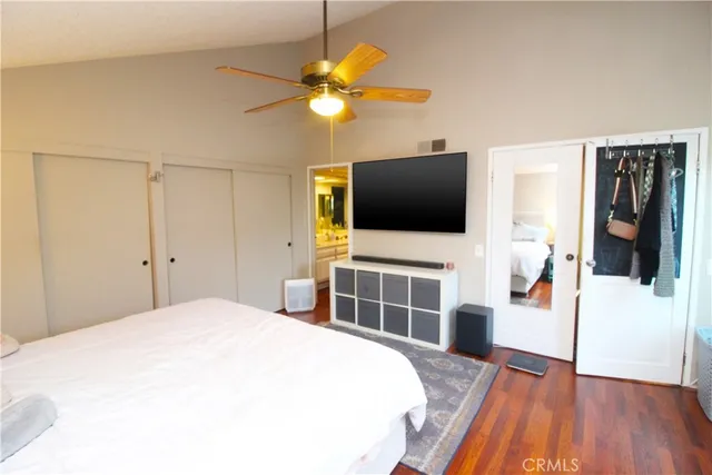 a bedroom with a bed and a flat screen tv