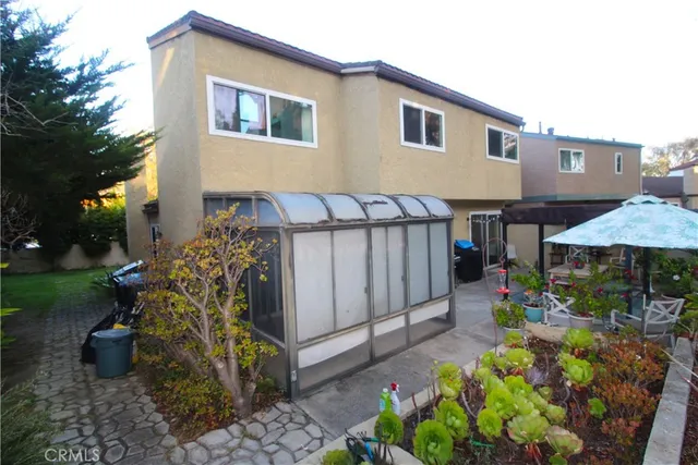 a patio view with a table and chairs and potted plants