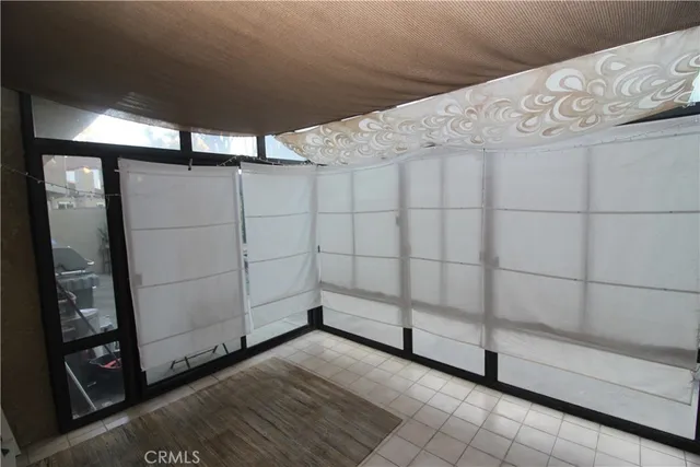 a view of a hallway with wooden floor and livingroom