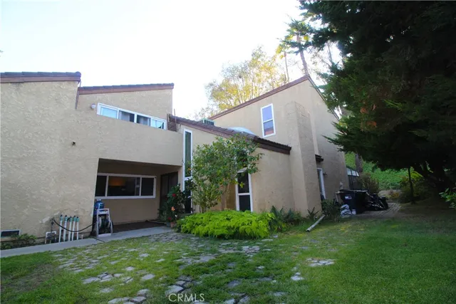 a house with beautiful flower in front of it
