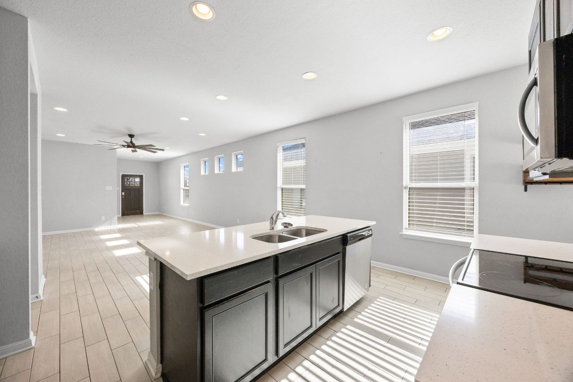 225 Unforgiven Lane Jarrell, TX 76537 - Photo 27 of 27 a kitchen with kitchen island a sink stove and refrigerator