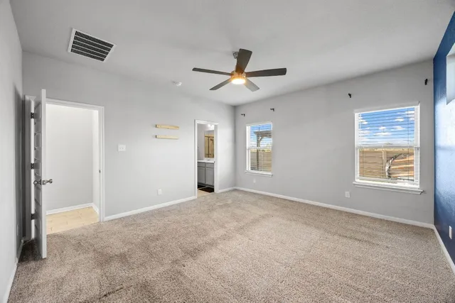 a bedroom with a bed couch and a window
