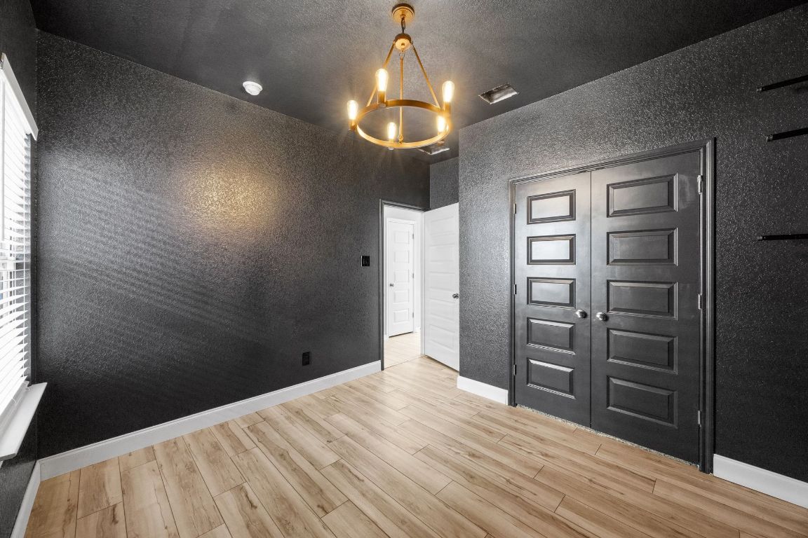 225 Unforgiven Lane Jarrell, TX 76537 - Photo 18 of 27 view of wooden floor and windows in a room