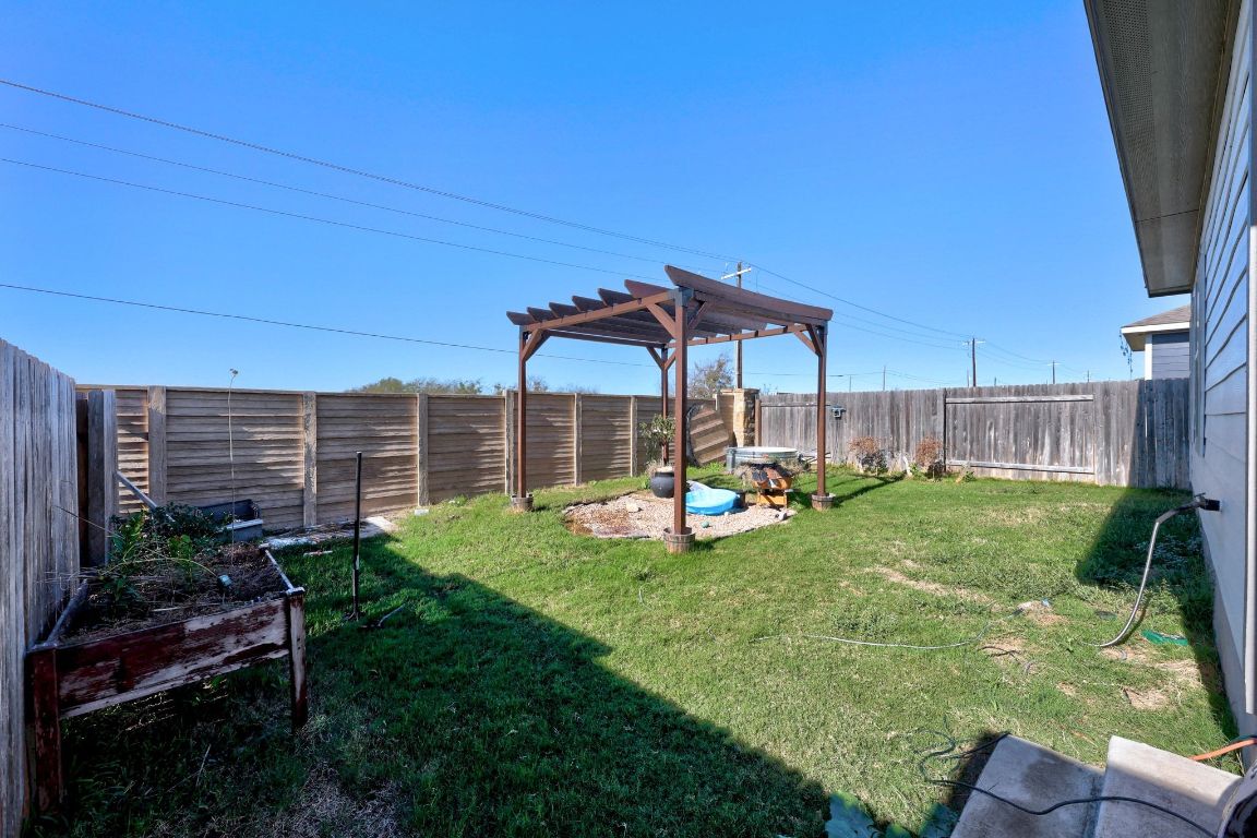 225 Unforgiven Lane Jarrell, TX 76537 - Photo 23 of 27 a view of backyard with seating area and green space