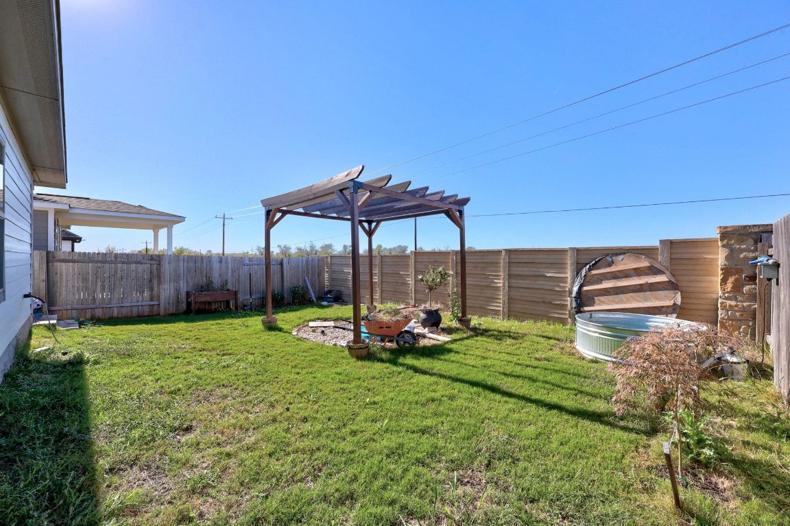225 Unforgiven Lane Jarrell, TX 76537 - Photo 25 of 27 a backyard of a house with barbeque oven