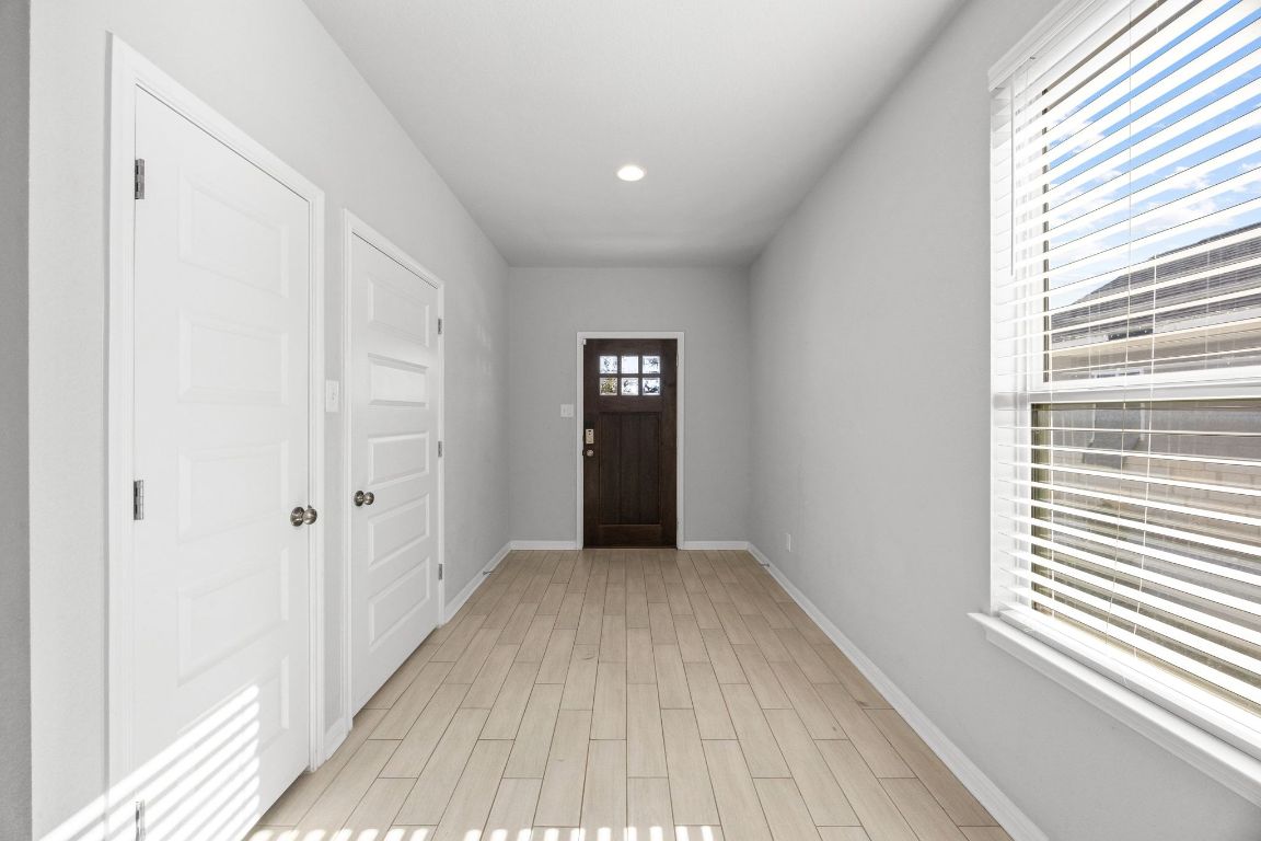225 Unforgiven Lane Jarrell, TX 76537 - Photo 3 of 27 a view of a hallway with wooden floor