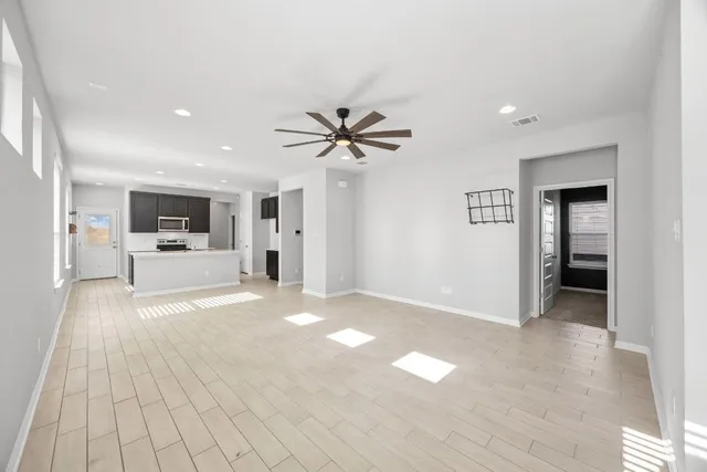 a view of an empty room with a kitchen
