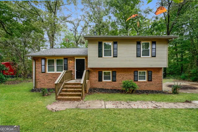 a front view of a house with a garden