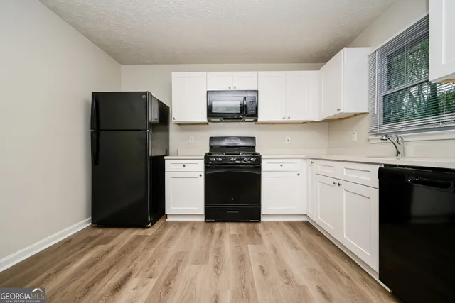 a kitchen with a refrigerator stove and sink