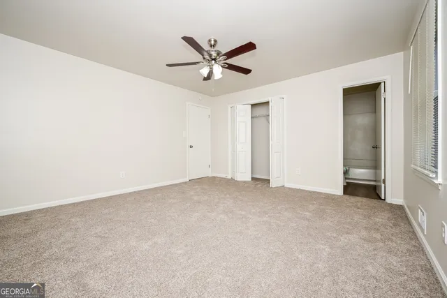 a view of a livingroom with a ceiling fan and window