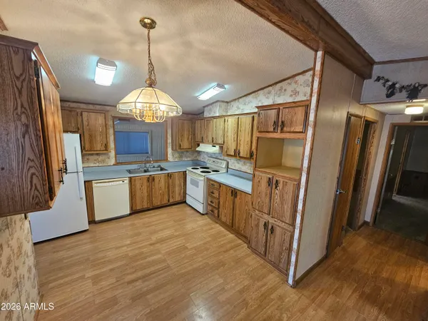 a kitchen with stainless steel appliances granite countertop sink window and refrigerator