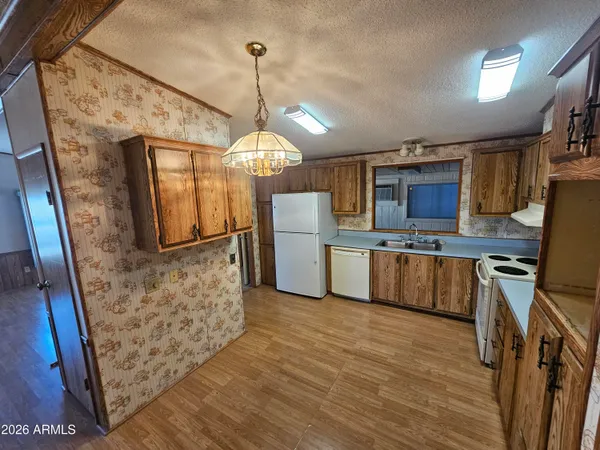 a kitchen with refrigerator cabinets and microwave