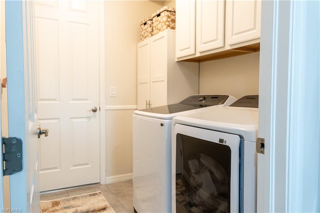 14888 Edgewater Circle Naples, FL 34114 - Photo 13 of 33 a utility room with dryer and washer