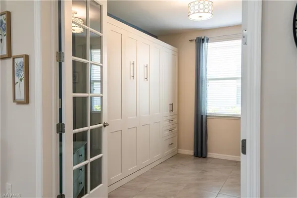 a view of a workspace with furniture and a window