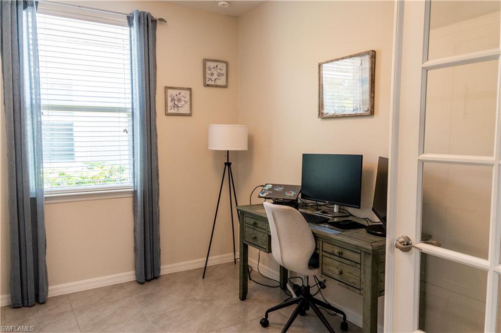 14888 Edgewater Circle Naples, FL 34114 - Photo 17 of 33 a view of a workspace with furniture and a window
