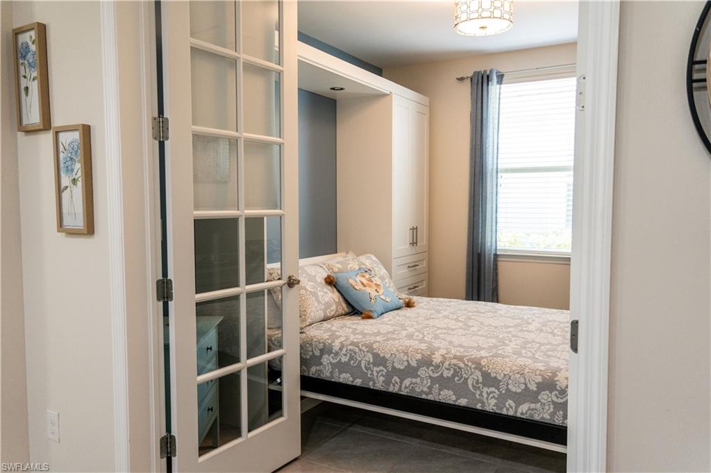 14888 Edgewater Circle Naples, FL 34114 - Photo 19 of 33 a bedroom with a bed and a window