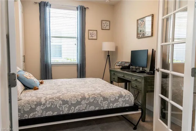 a bedroom with a bed and a window