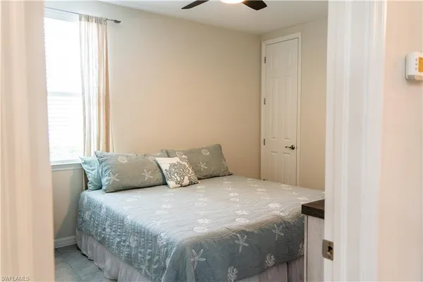 a large bed sitting in a bedroom next to a window